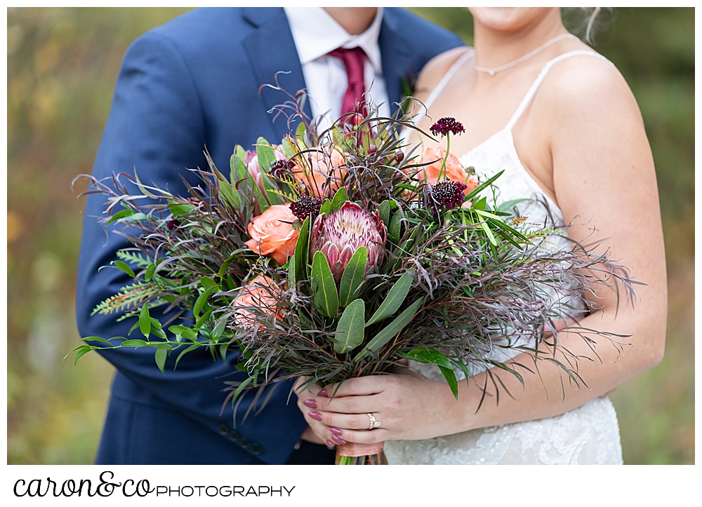 a bride's bouquet of peach roses and greens