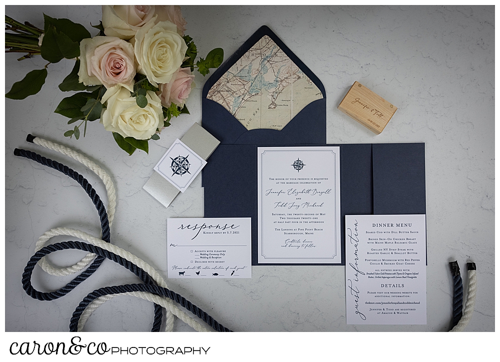 Wedding day details of a Pine Point Maine wedding, navy and white invitations, flowers, ring box, and white and navy rope