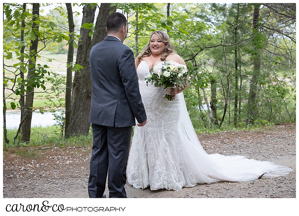 bride smiles at her groom during a Pine Point Maine wedding day first look