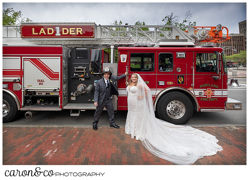 A bride and groom stand in front of Ladder 1 of the Portland, Maine fire department, Portland, Maine