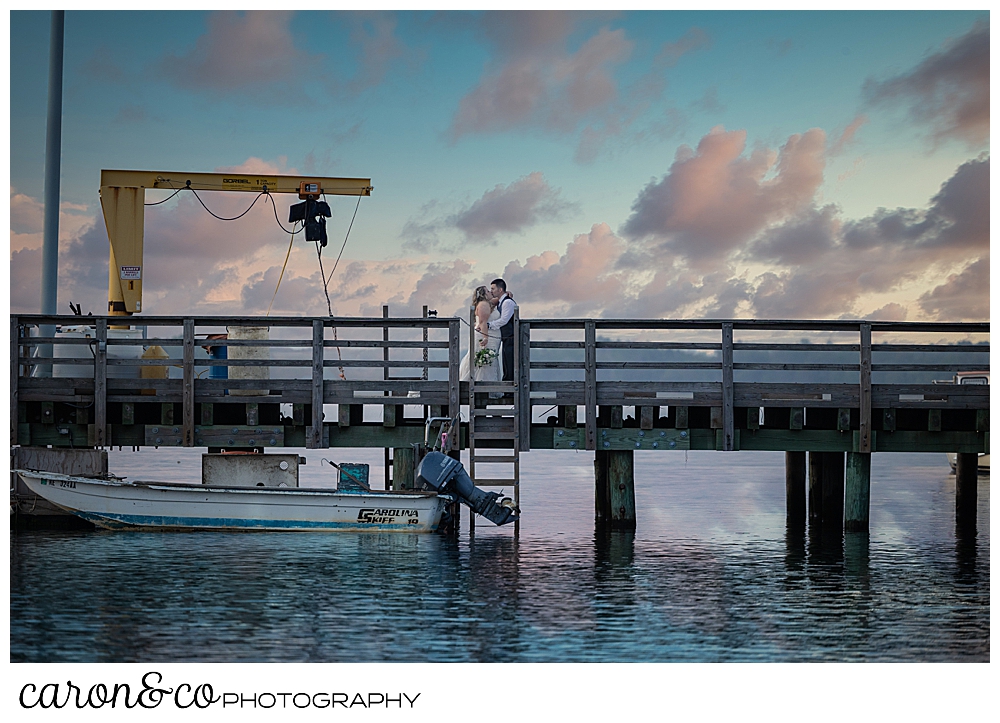 a bride and groom pose at the fisherman's coop at Pine Point Scarborough Maine