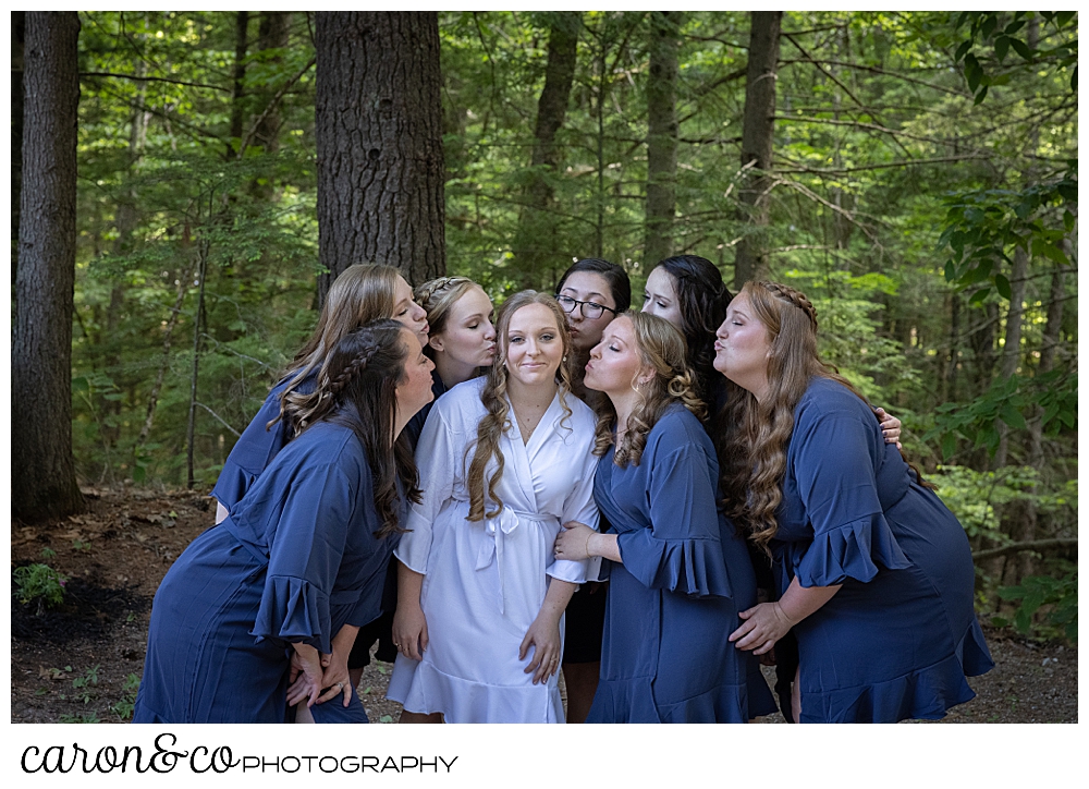 bridesmaids in blue robes, kiss the bride in a white robe