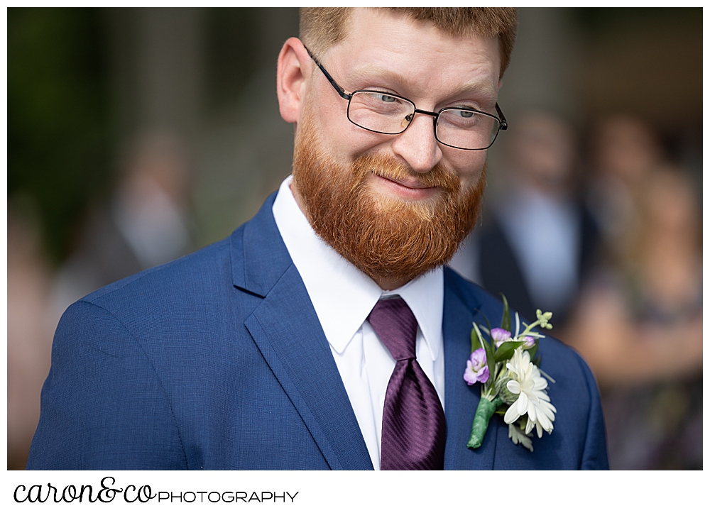 groom looking at his bride during their highland lake maine wedding ceremony