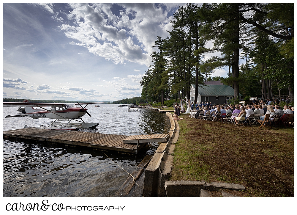 a highland lake wedding ceremony with a sea plane at the dock, Bridgton Maine wedding photographers