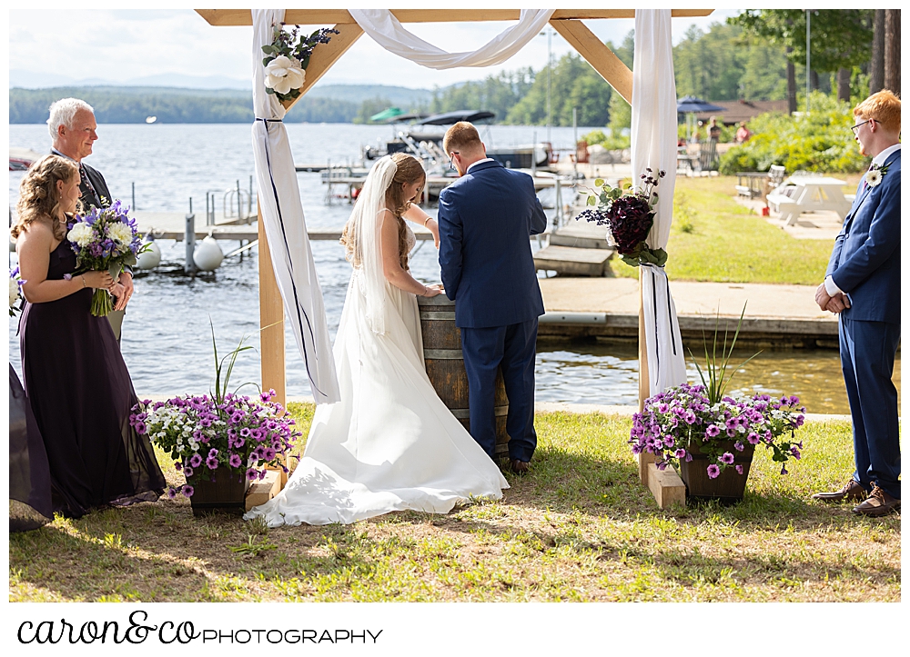 bride and groom during a sand ceremony at their highland lake maine wedding