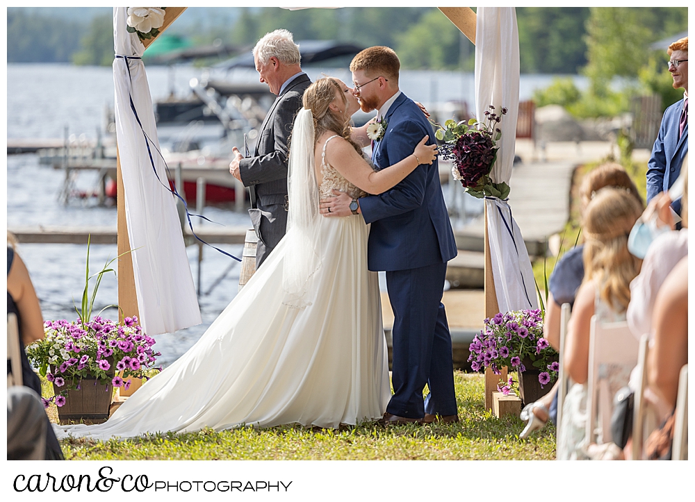 bride and groom during the first kiss at their highland lake maine wedding