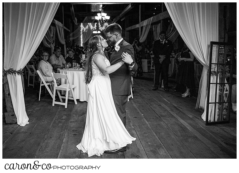 black and white photo of a bride and groom dancing their first dance