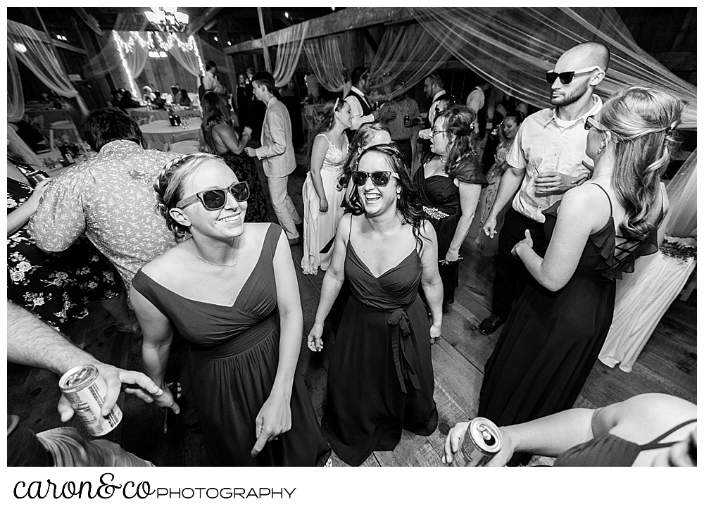 black and white photo of guests wearing sunglasses on the dance floor during a Harrison Maine wedding reception