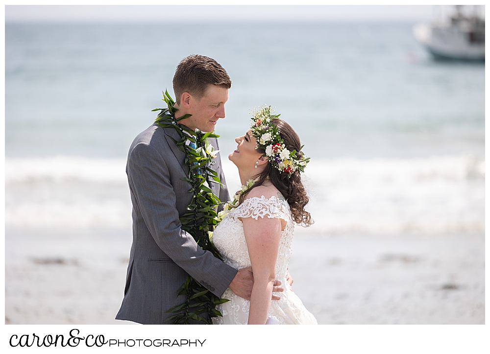 a bride and groom hug each other face to face on Colony Beach, Kennebunkport, Maine