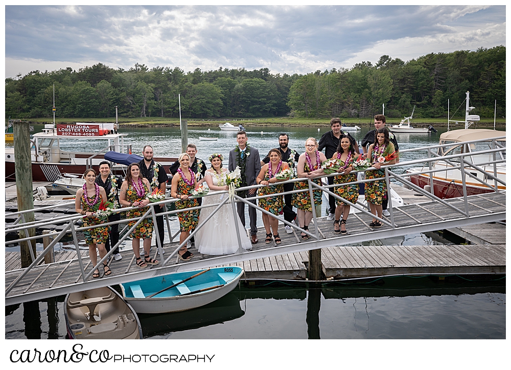 a bride and groom stand with their bridal party on the dock at the Nonantum Resort, Kennebunkport, Maine