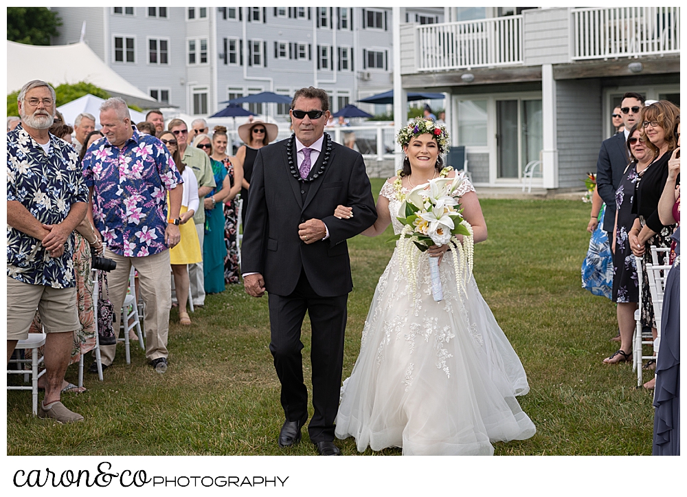 a bride and groom walk towards the groom, at their outdoor wedding at the Nonantum Resort, Kennebunkport, Maine