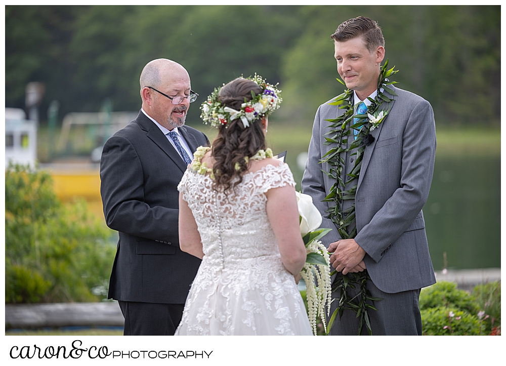 a groom looks at his bride during an outdoor wedding ceremony at the Nonantum Resort, Kennebunkport, Maine