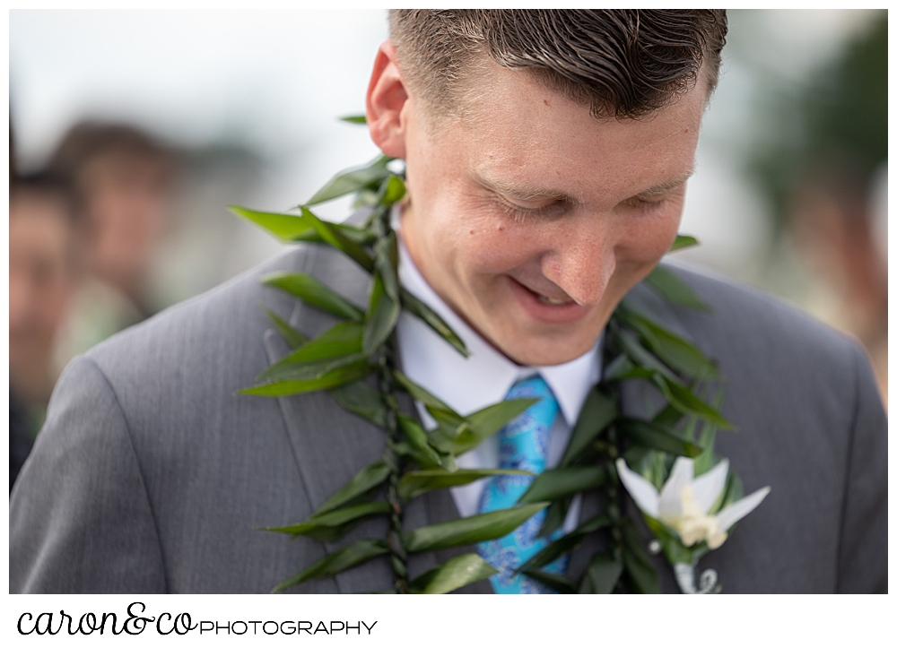 a groom smiles during a hawaiian themed wedding ceremony