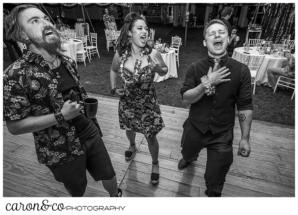 black and white photo of guests singing to the music at a Nonantum Resort tented wedding reception