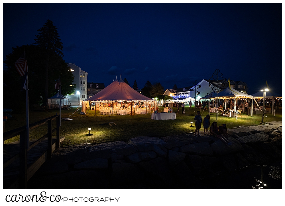 A tented wedding at the Nonantum Resort, Kennebunkport, Maine, glows in the summer twilight