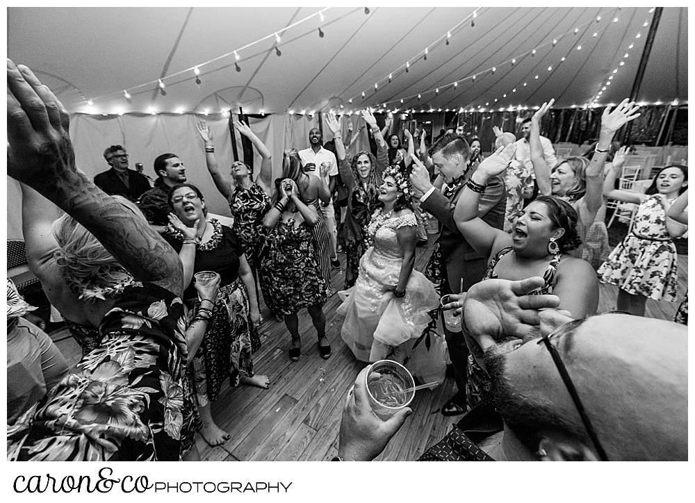 black and white photo of wedding guests dancing at a Nonantum Resort tented wedding reception