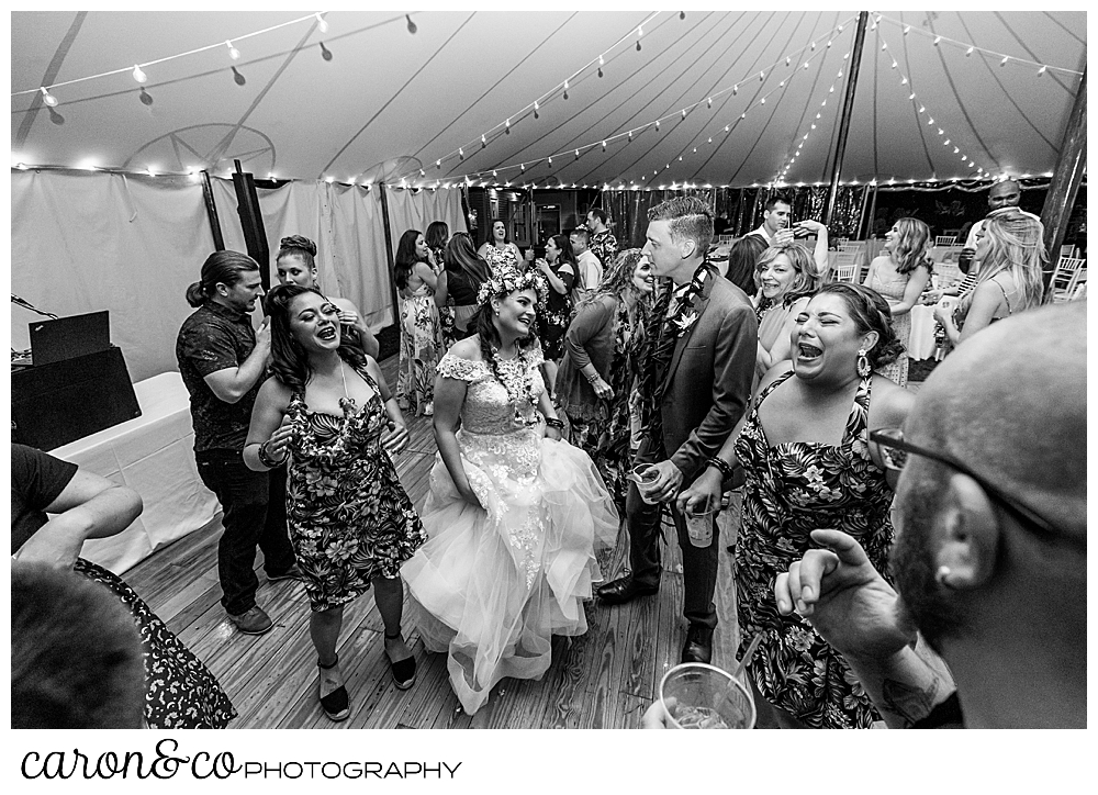 black and white photo of a bride dancing with her wedding guests under a tent at the Nonantum Resort, Kennebunkport, Maine