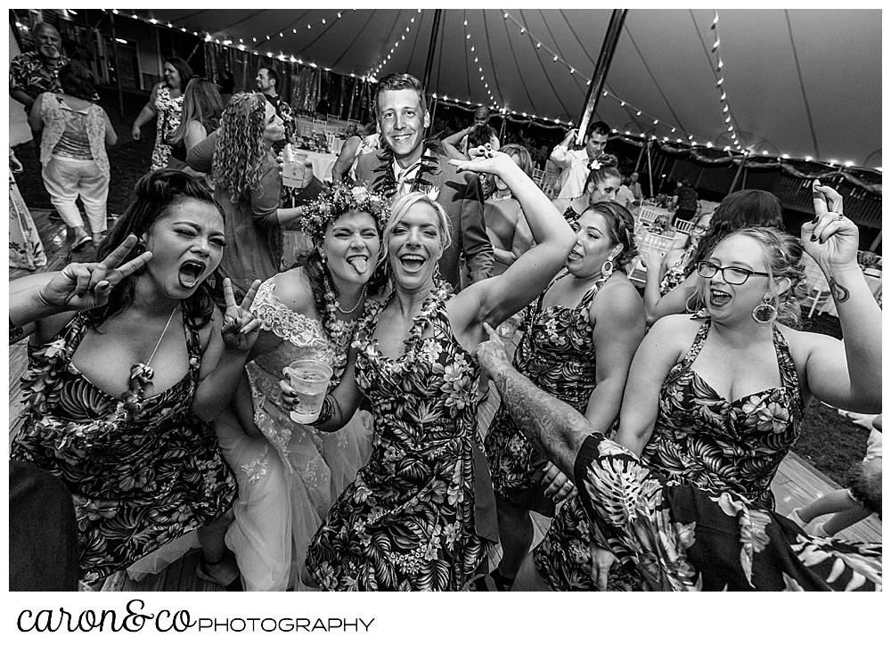 black and white photo of a bride having fun with friends at a tented wedding at the Nonantum Resort, Kennebunkport, Maine