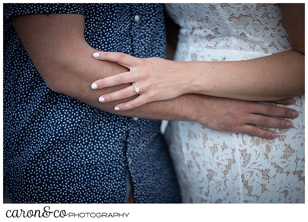 the torso of a man and woman hugging each other, the woman has an engagement ring, during their Kennebunkport engagement session