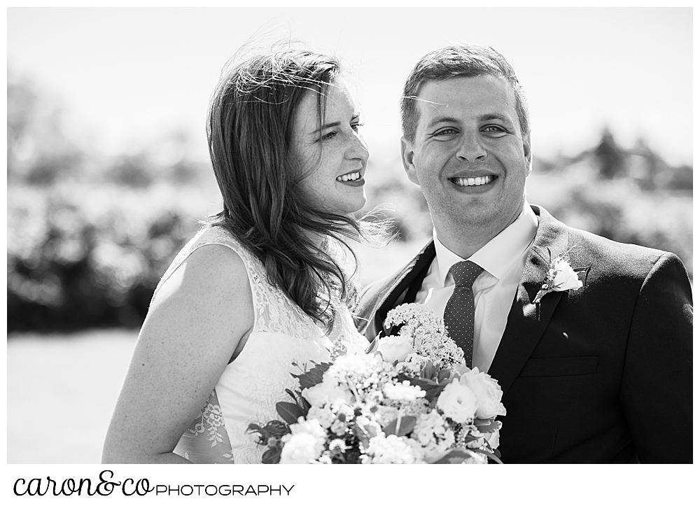 black and white photo of a bride and groom smiling