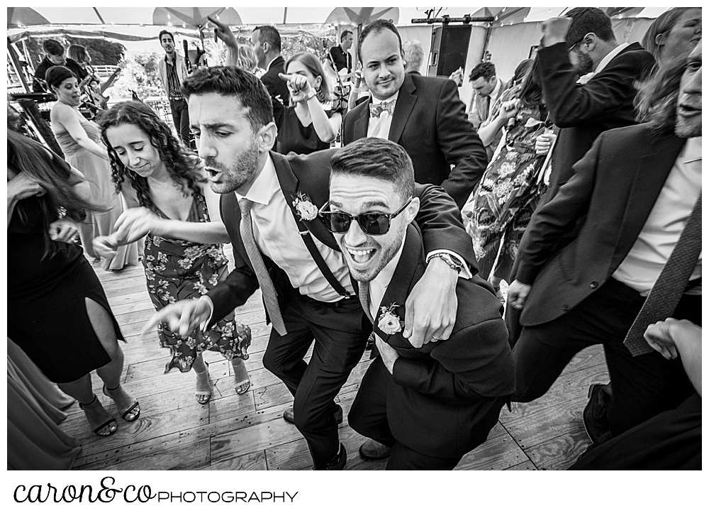 black and white photo of wedding guests having fun on the dance floor