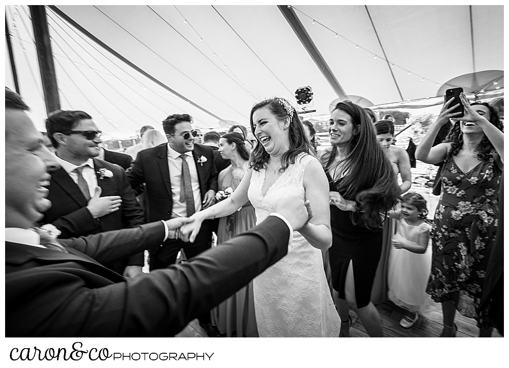 black and white photo of a bride and her wedding guests dancing at a Nonantum Resort wedding celebration