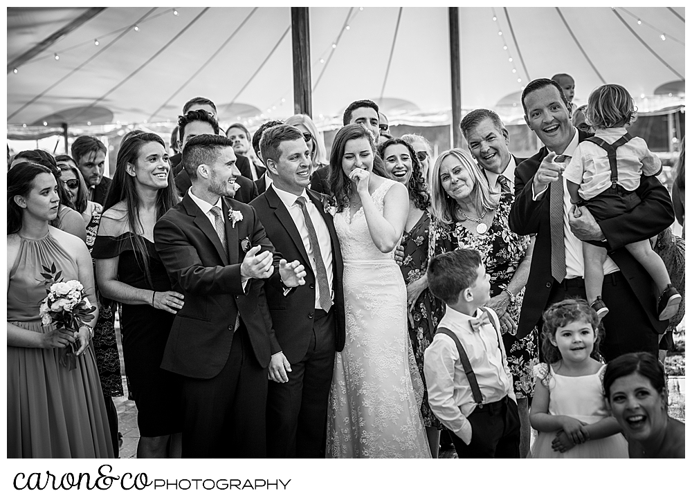 black and white photo of a bride and groom and their guests paying tribute to the past year of their highs and lows, during their Nonantum Resort wedding celebration