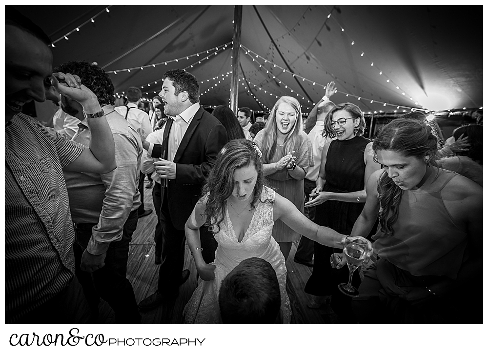 black and white photo of a bride and her guests having fun on the dance floor during a Nonantum Resort wedding celebration