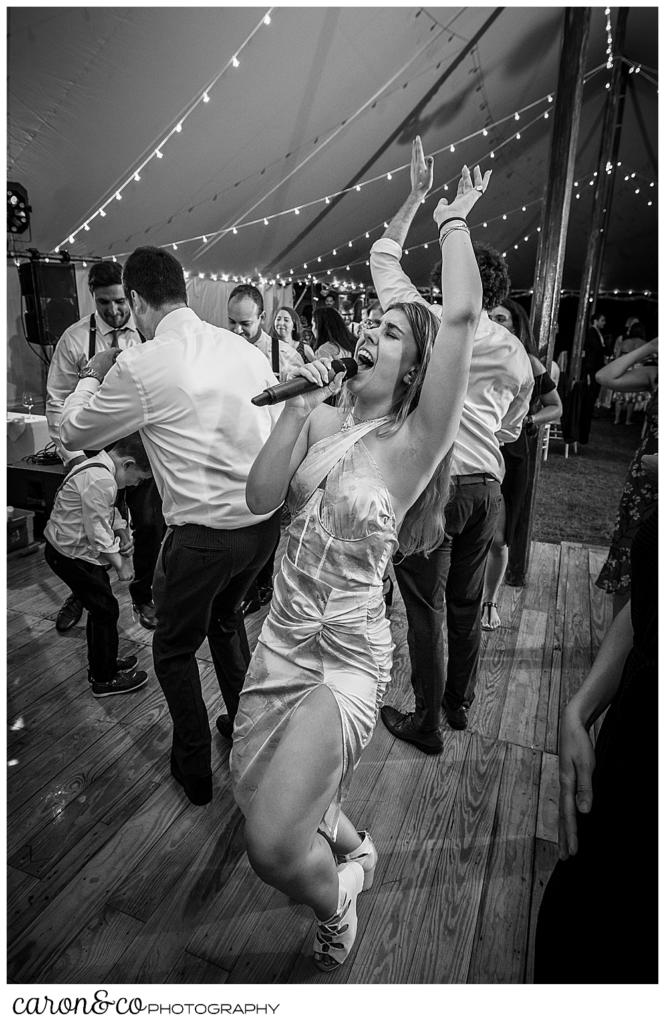 black and white photo of a female singer from the band Cover Story, in the middle of the dance floor of a Nonantum Resort wedding celebration