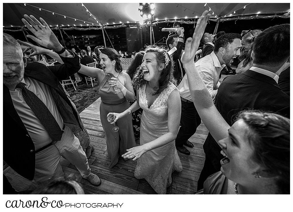 black and white photo of a bride dancing under a tent at her Nonantum Resort wedding celebration