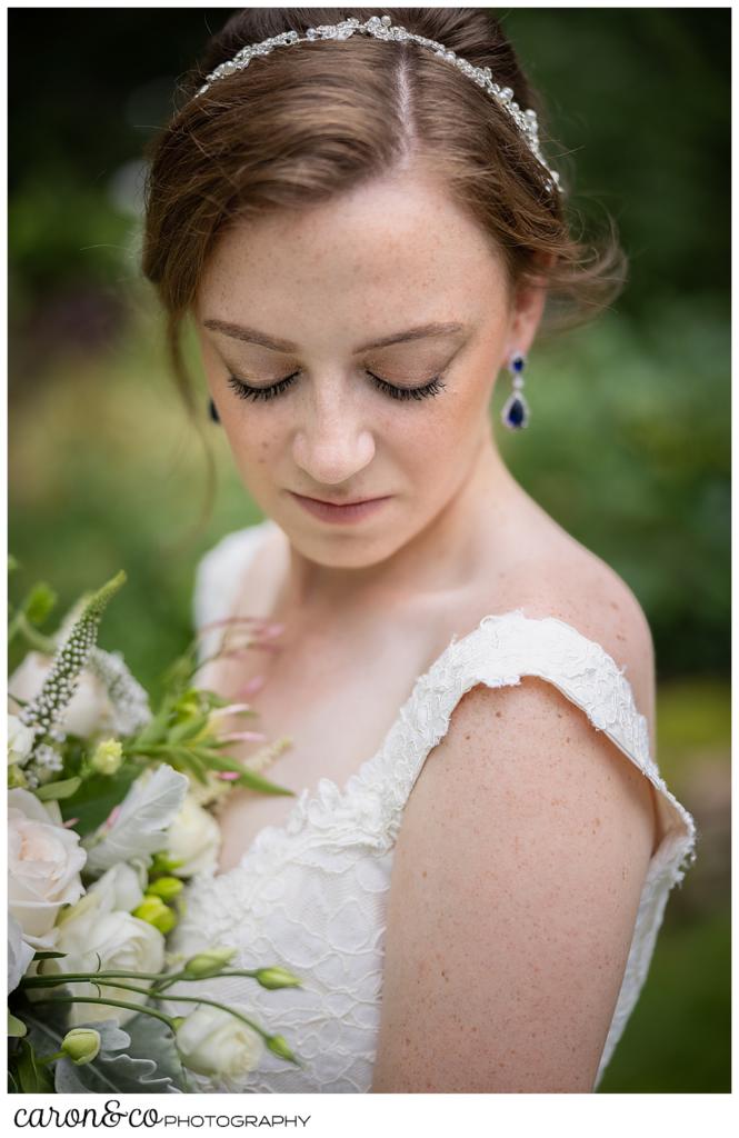 a beautiful bride with her eyes closed, holding a bouquet