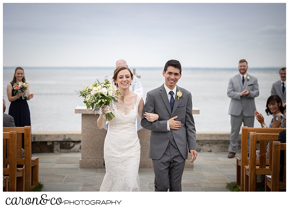 a bride and groom during their recessional at a St. Ann's by-the-sea Episcopal Church outdoor ceremony, Kennebunkport, Maine