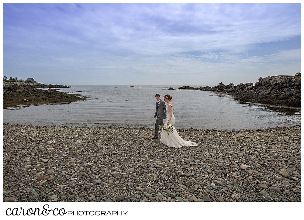 a bride and groom walk on a Kennebunkport Beach, during their Kennebunk Maine wedding