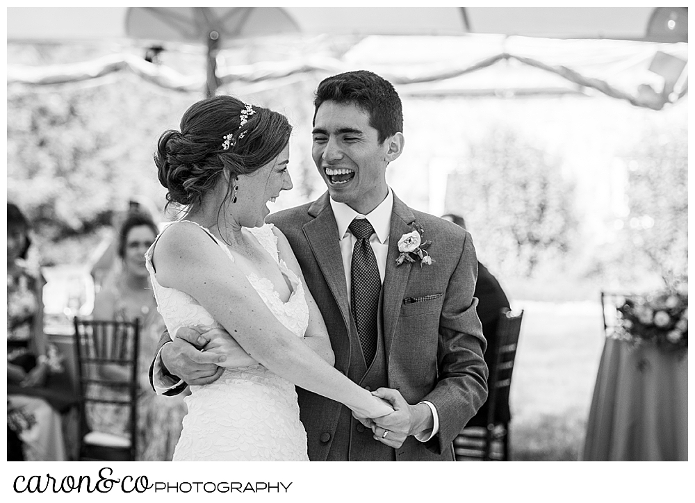 black and white photo of a bride and groom laughing during their first dance at a Kennebunk Maine wedding reception