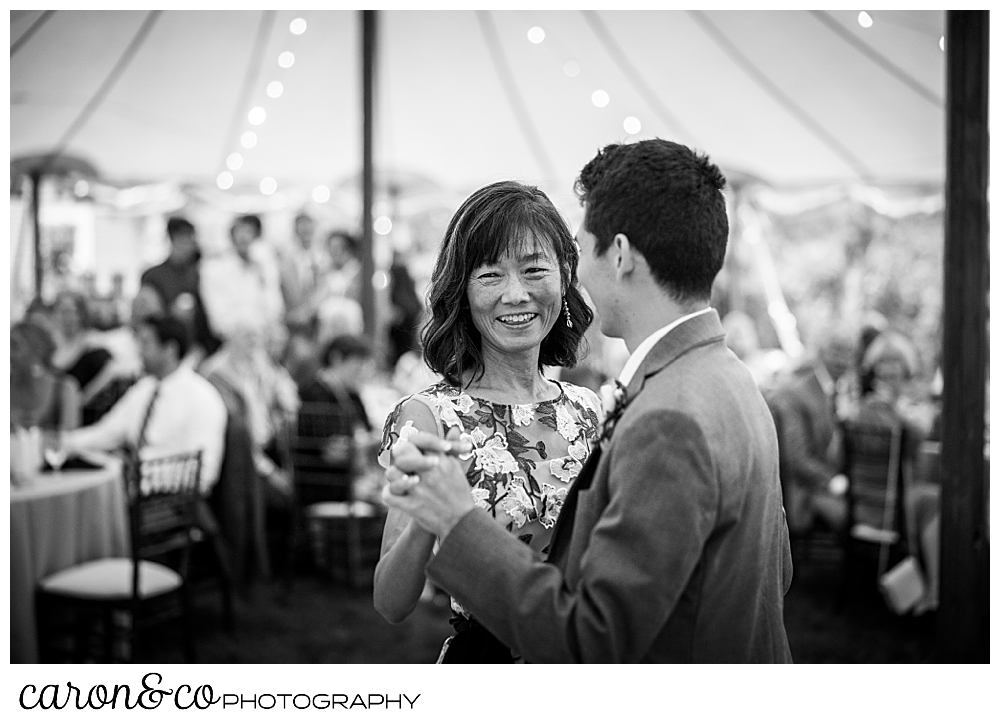 black and white photo of the mother of the groom smiling during the mother son dance at a Kennebunk Maine wedding reception