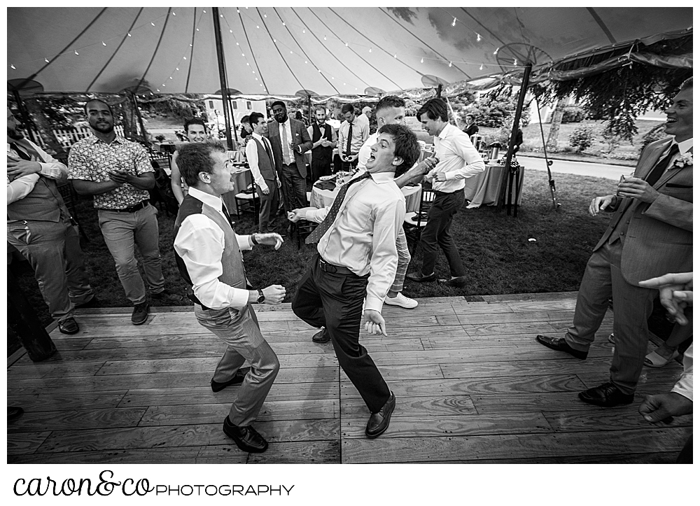 black and white photo of two guys dancing during a tented Kennebunk Maine wedding reception