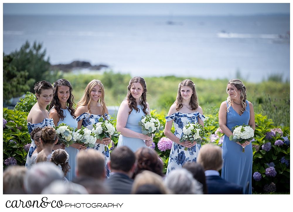 6 bridesmaids lined up at a wedding, 3 are wearing blue, 3 are wearing blue flowered dresses at a Kennebunkport wedding at the Colony Hotel