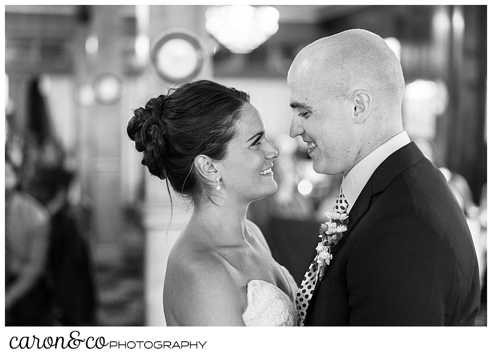 black and white photo of a bride and groom smiling at each other as they dance their first dance at a Kennebunkport wedding at the Colony Hotel