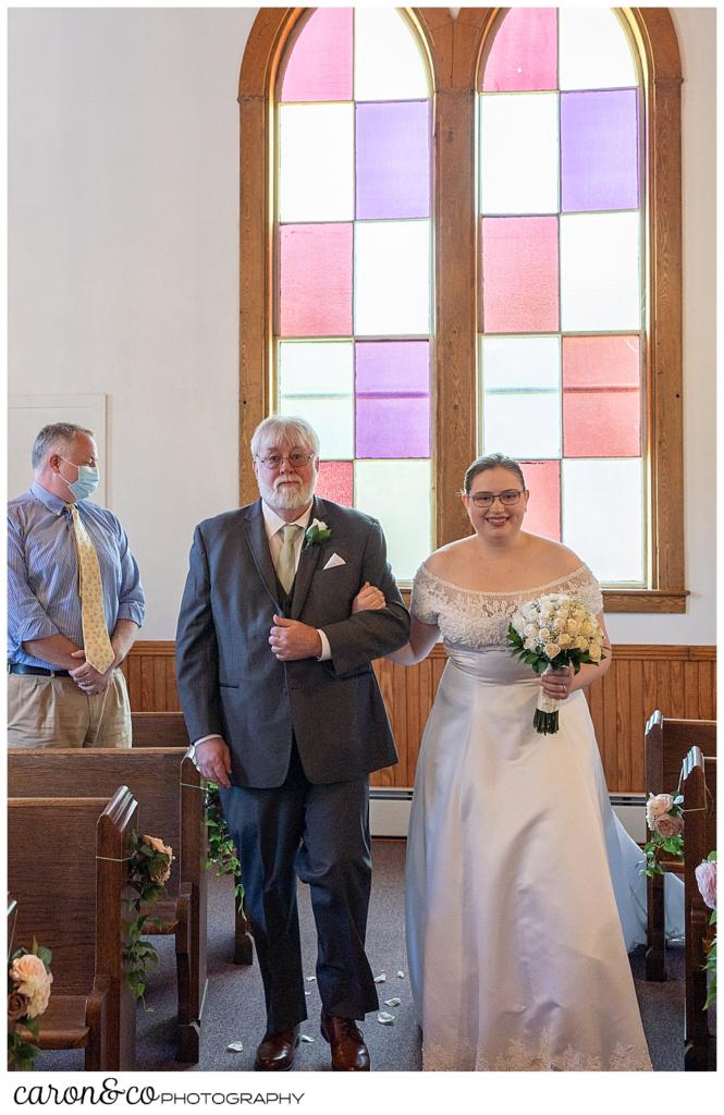 a bride and her father during the processional at the Peru Maine Baptist Church