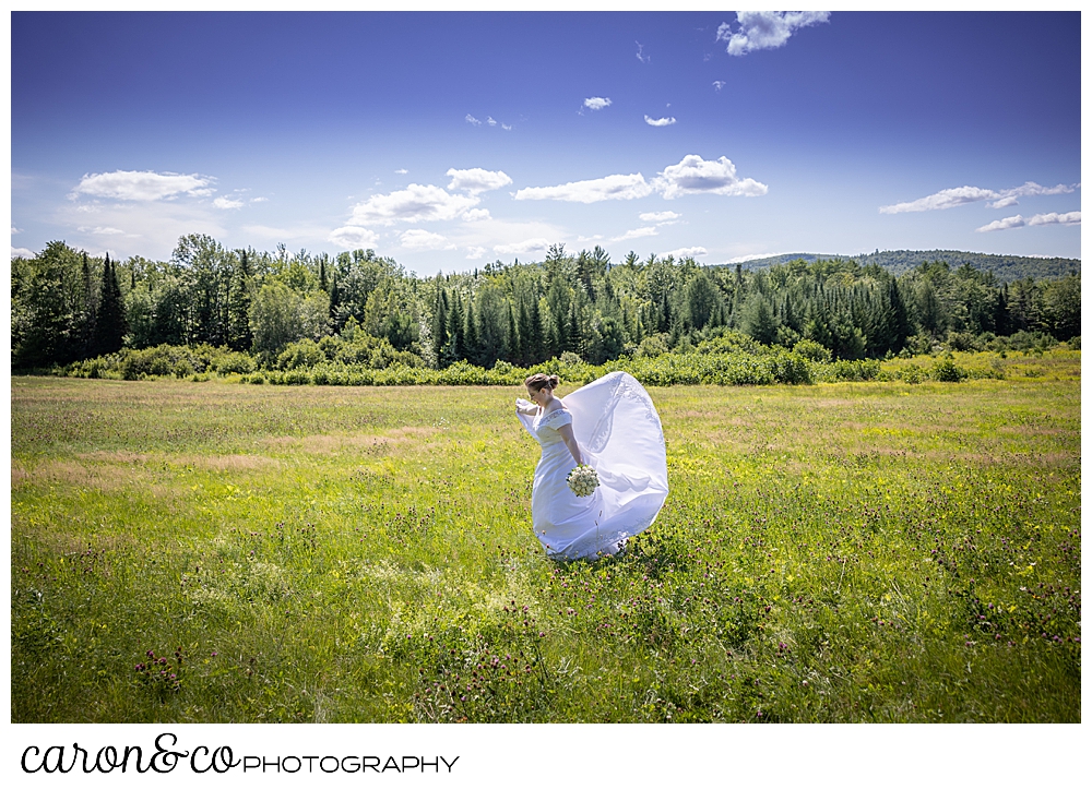 a bride twirls in a field in western Maine