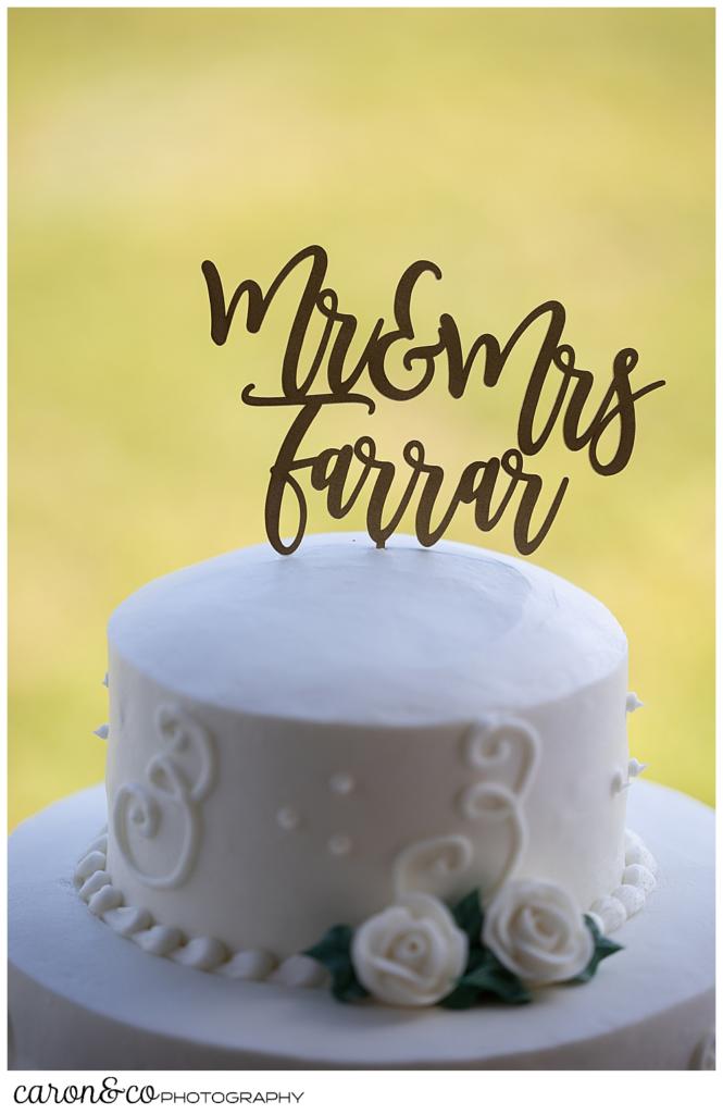 wedding cake topper with brush lettering of "Mr & Mrs Farrar"