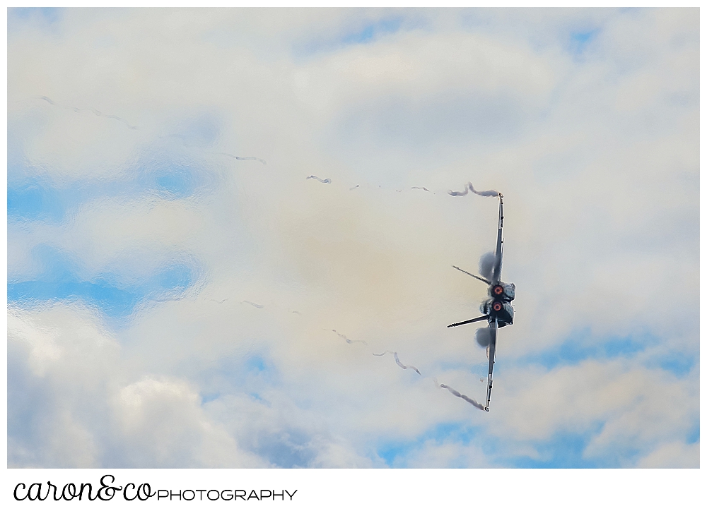 a us navy blue angel flying vertically during the Great State of Maine Airshow over Brunswick, Maine