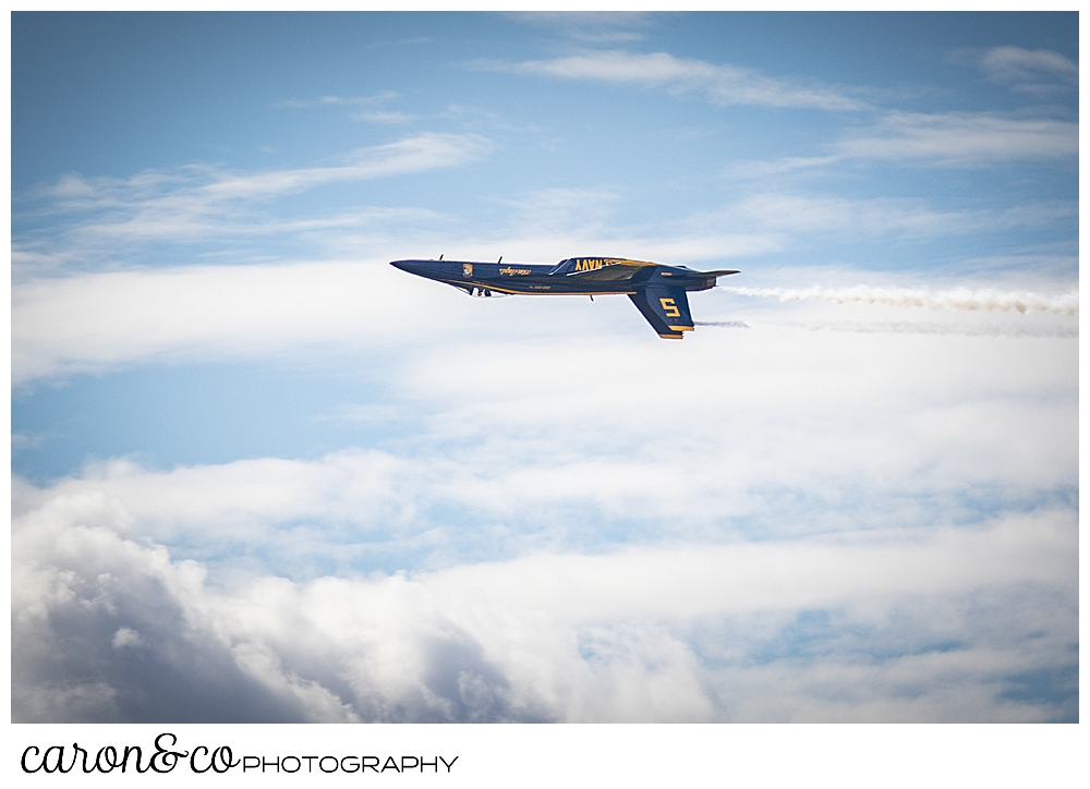 a single us navy blue angel flies upside down