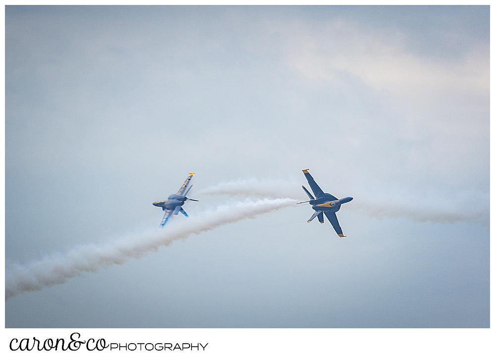 two us navy blue angels fly towards each other, veering off at the last minute