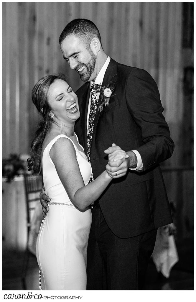 black and white photo of a bride and groom dancing their first dance at a Camp Skylemar wedding reception, they're both smiling