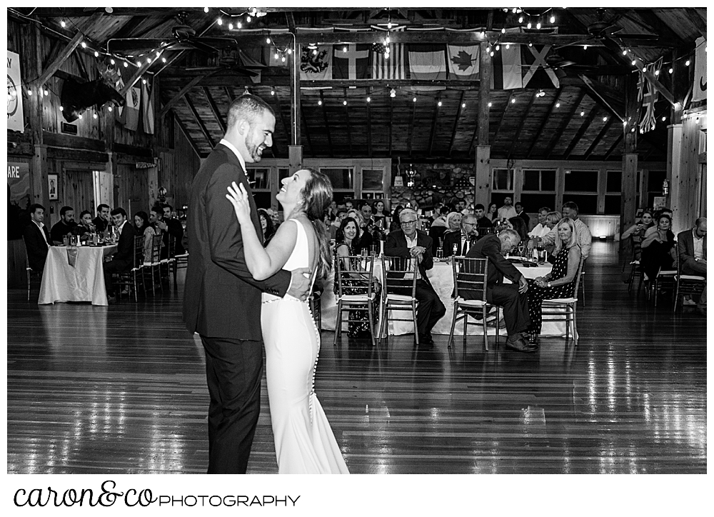 black and white photo of a bride and groom dancing in the main lodge at their Camp Skylemar wedding reception