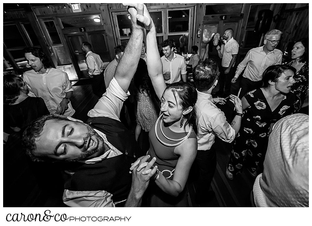 black and white photo of wedding guests dancing at a Camp Skylemar wedding reception