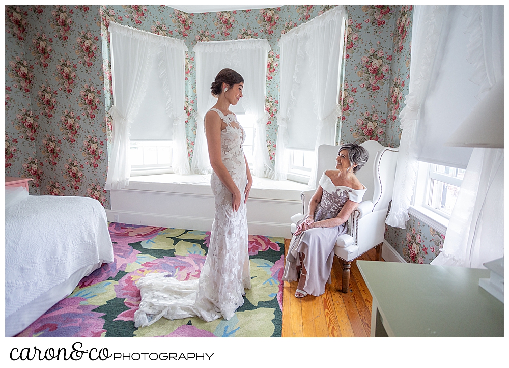 a bride stands before her mother, who is seated in a chair, at a coastal maine wedding at the colony hotel Kennebunkport maine