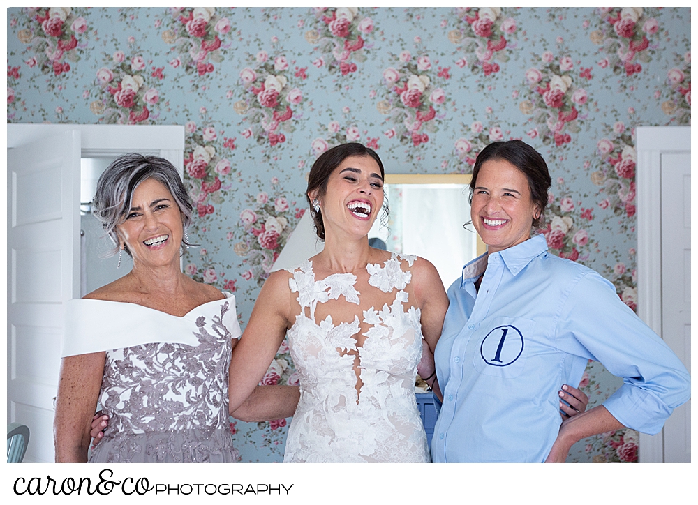 a bride, standing between her mother and a bridesmaid, laughs during a coastal Maine wedding at the Colony Hotel Kennebunkport Maine