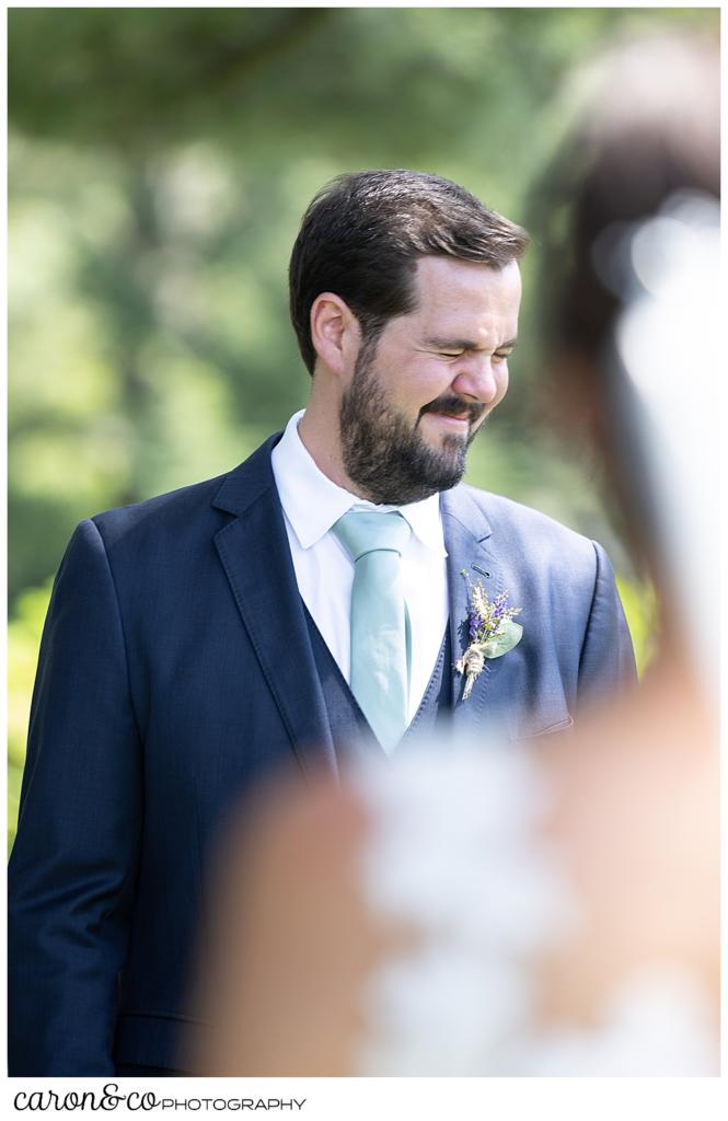 a groom, shuts his eyes tight as he approaches his bride during a Maine wedding day first look at the Colony Hotel, Kennebunkport, Maine